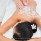 Peaceful brunette getting a salt scrub beauty treatment in the h